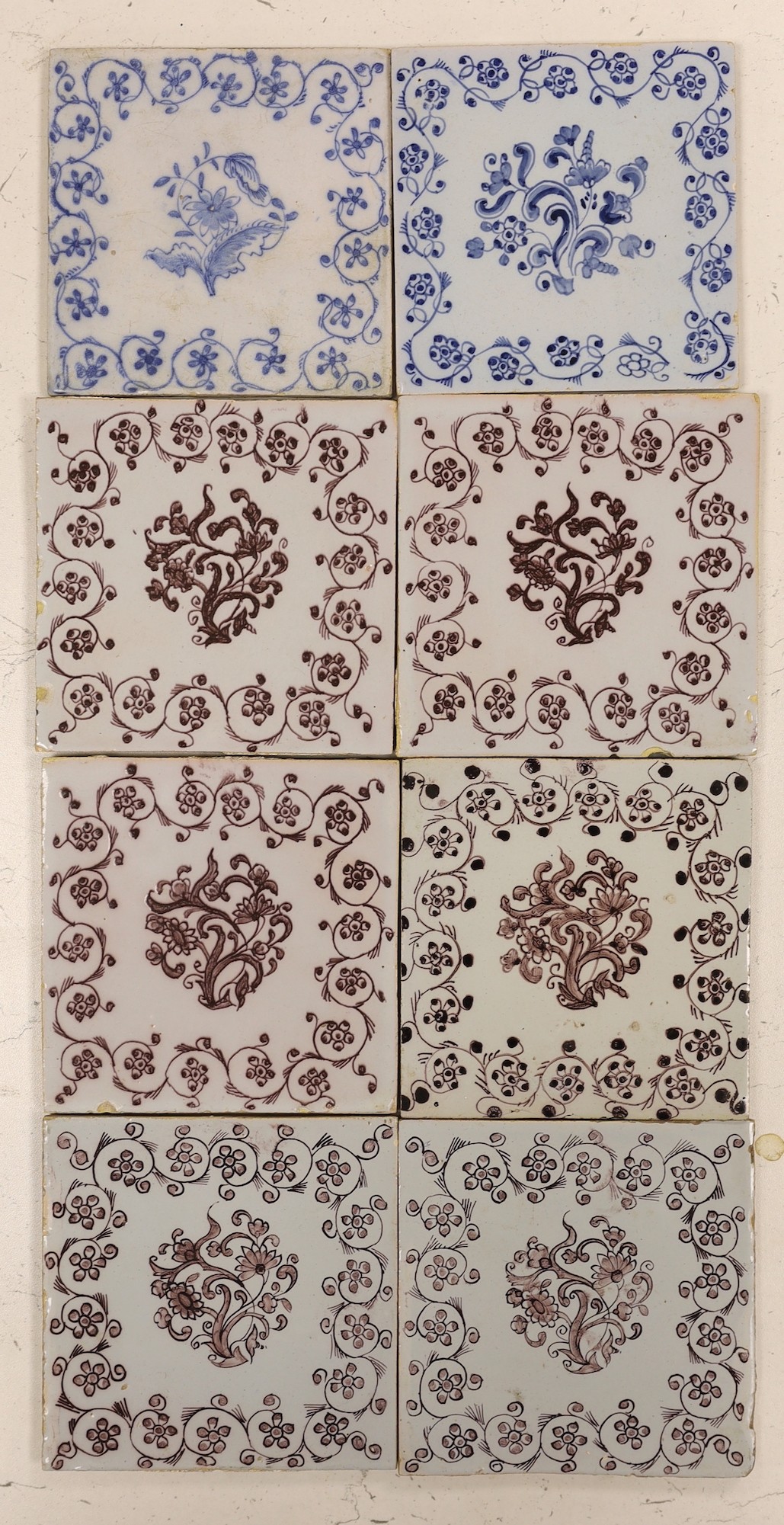 Six 18th/19th century Delft manganese flower spray tiles and two similar blue and white tiles, 18th century (8)